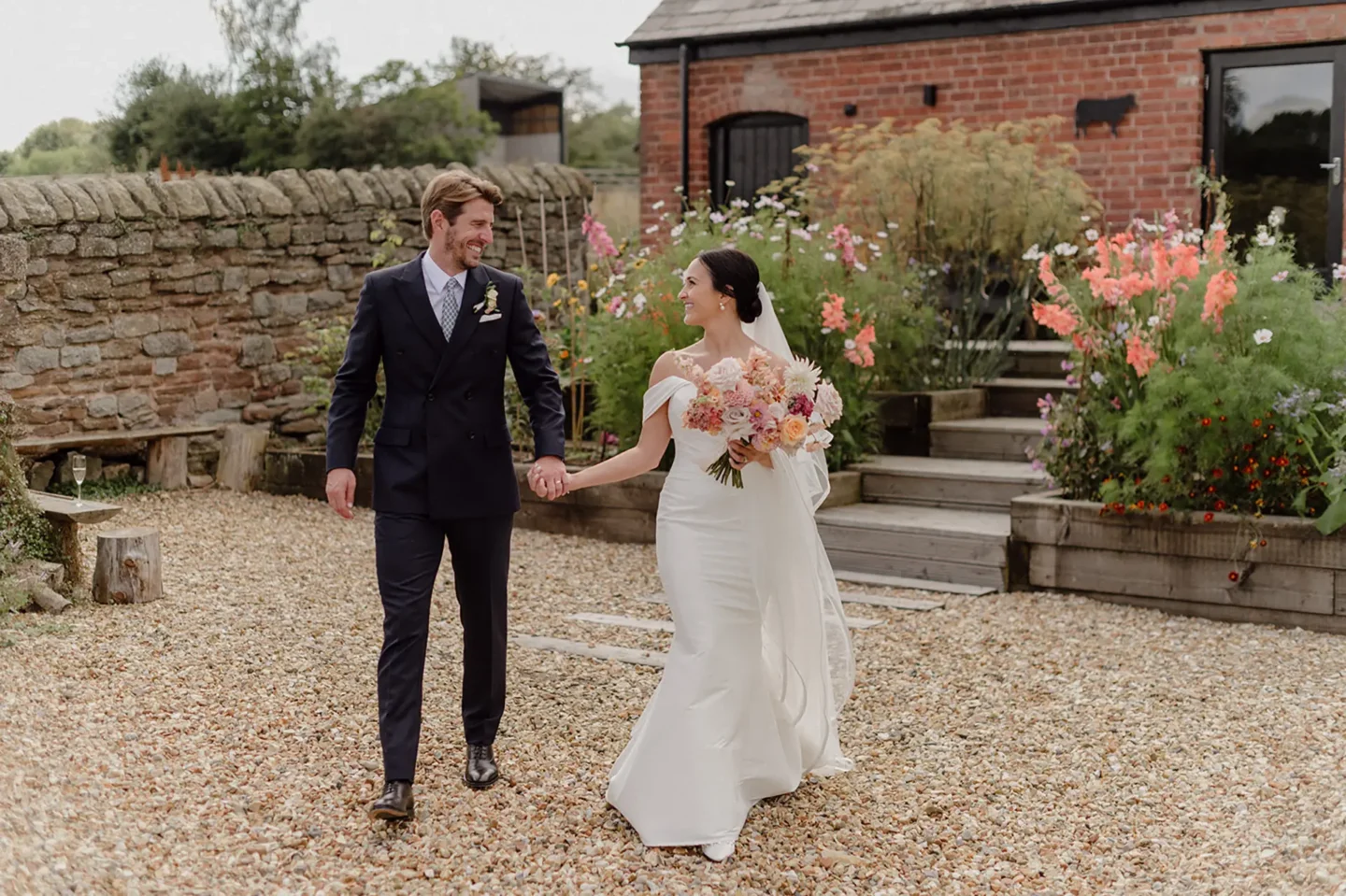 bride and groom walking hand in hand at crumplebury