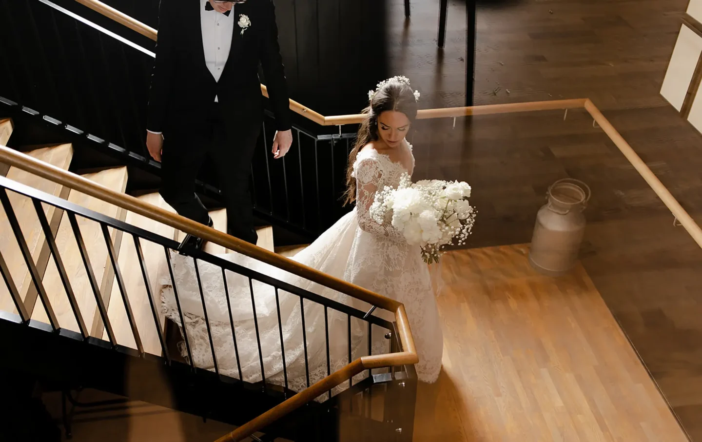 bride and groom walking down staircase